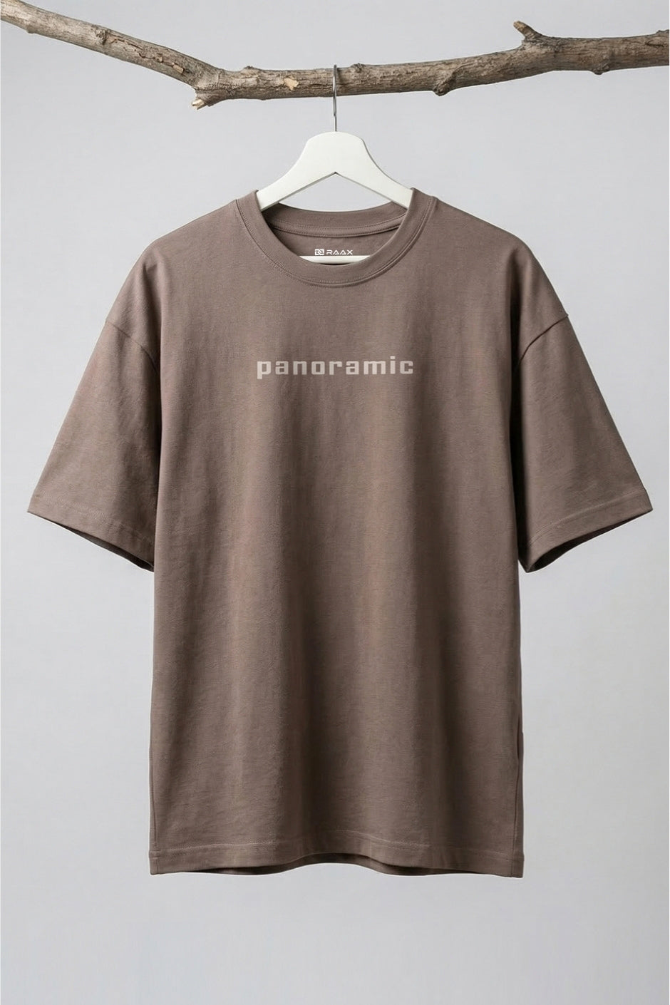 Chocolate t-shirt with 'panoramic' text on a hanger against a gray background