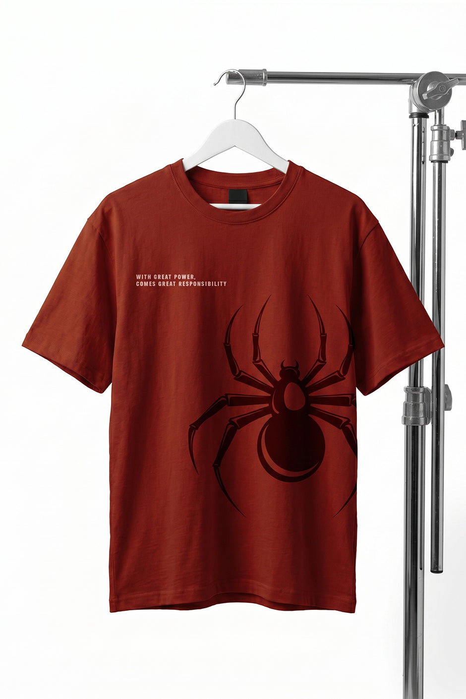 Rust t-shirt with a black spider design on a white background