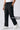Person wearing black cargo jogger with boxy side utility pockets on a white background