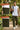 Man walking outdoors wearing olive joggers with text highlighting features like soft elastic waistband and adjustable drawcord cuffs.