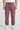 Person wearing plum cargo jogger on a white background