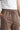 Chocolate jogger with a drawstring on a neutral background