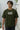 Man wearing an 'Oversize Fit' olive t-shirt with 'Born Unbroken' text.