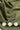 Close-up of olive fabric with wicking, hypoallergenic, and lightweight icons.