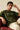 Man wearing a green 'Dystopia' t-shirt sitting on a red couch.
