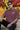 Man wearing a plum t-shirt with 'Street Punk' text, sunglasses, and black cap in front of graffiti.
