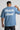Person wearing a light blue t-shirt with 'Artistic street' text on the back against a gray background