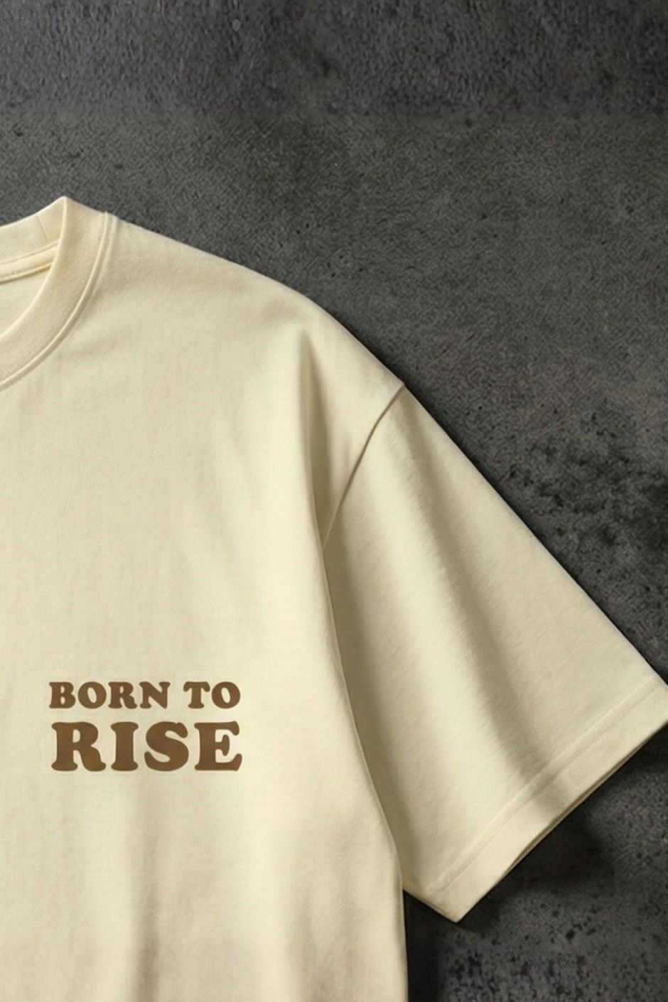 Offwhite t-shirt with 'Born to Rise' text on a dark textured surface