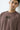 Man wearing a chocolate t-shirt with text on a plain background