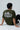 Person wearing a olive t-shirt with 'DIFFUSE' logo on the back, sitting on a light gray floor.