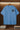 Light blue t-shirt with 'FREE DOM STREET WEAR' text on a wooden background.