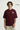 Person wearing a maroon red t-shirt with 'FUTURE' text on a plain background