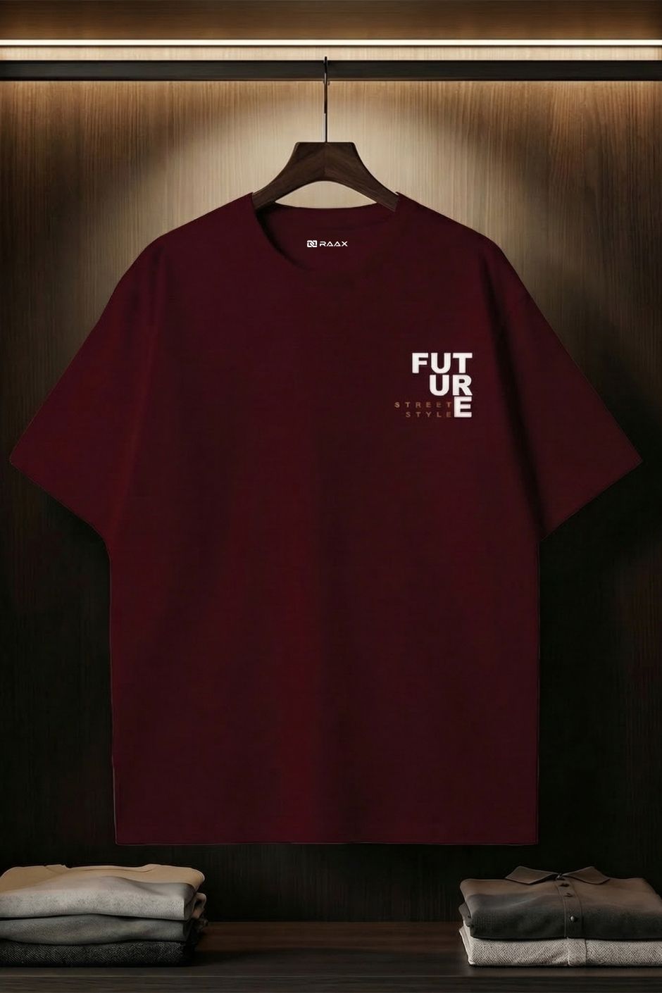 Maroon red t-shirt with 'FUTURE' text on a hanger against a dark background