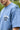Light blue t-shirt with 'North Edge' and '57' printed on it, worn by a person.