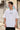 Person wearing a white t-shirt with 'nothing.' text in an urban setting