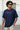 Man wearing a royal blue t-shirt with 'Outer Space' text, standing outdoors.