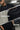 Black t-shirt with 'raax' branding worn by a person, with text indicating features like 'Crew Neck', 'HD Print Design', and 'Loose Fit'.