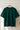 Bottle green t-shirt on a wooden hanger against a white wall