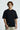 Person wearing a black t-shirt with text on a white background