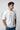 Man wearing a white t-shirt on a light gray background