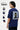 Man wearing a royal oversized t-shirt with graphic design on the back, showing different sleeve lengths.