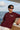 Man wearing a rust 'RIDERS' t-shirt on a boat with ocean and sky background