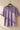Lilac t-shirt with 'Ruthless' text on a hanger against a beige wall