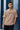 Man wearing a light beige t-shirt with 'STEREO' text against a blue wall.