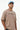 Man wearing a light beige t-shirt with 'STEREO' text and a light blue cap on a white background
