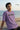 Man wearing a lilac t-shirt with 'Straight Forward' text on a beach