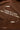Brown tshirt with white text and quality indicators on a brown background