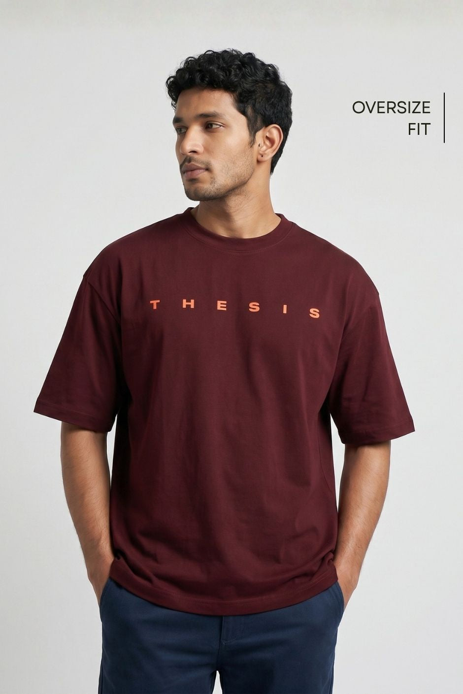 Man wearing a maroon red t-shirt with 'THE SIS' text on a white background