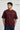 Man wearing a maroon red t-shirt with 'THE SIS' text on a white background