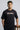 Man wearing a black t-shirt with 'Tokyo Nights' text on a gray background