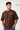 Man wearing a brown t-shirt with text on a white background