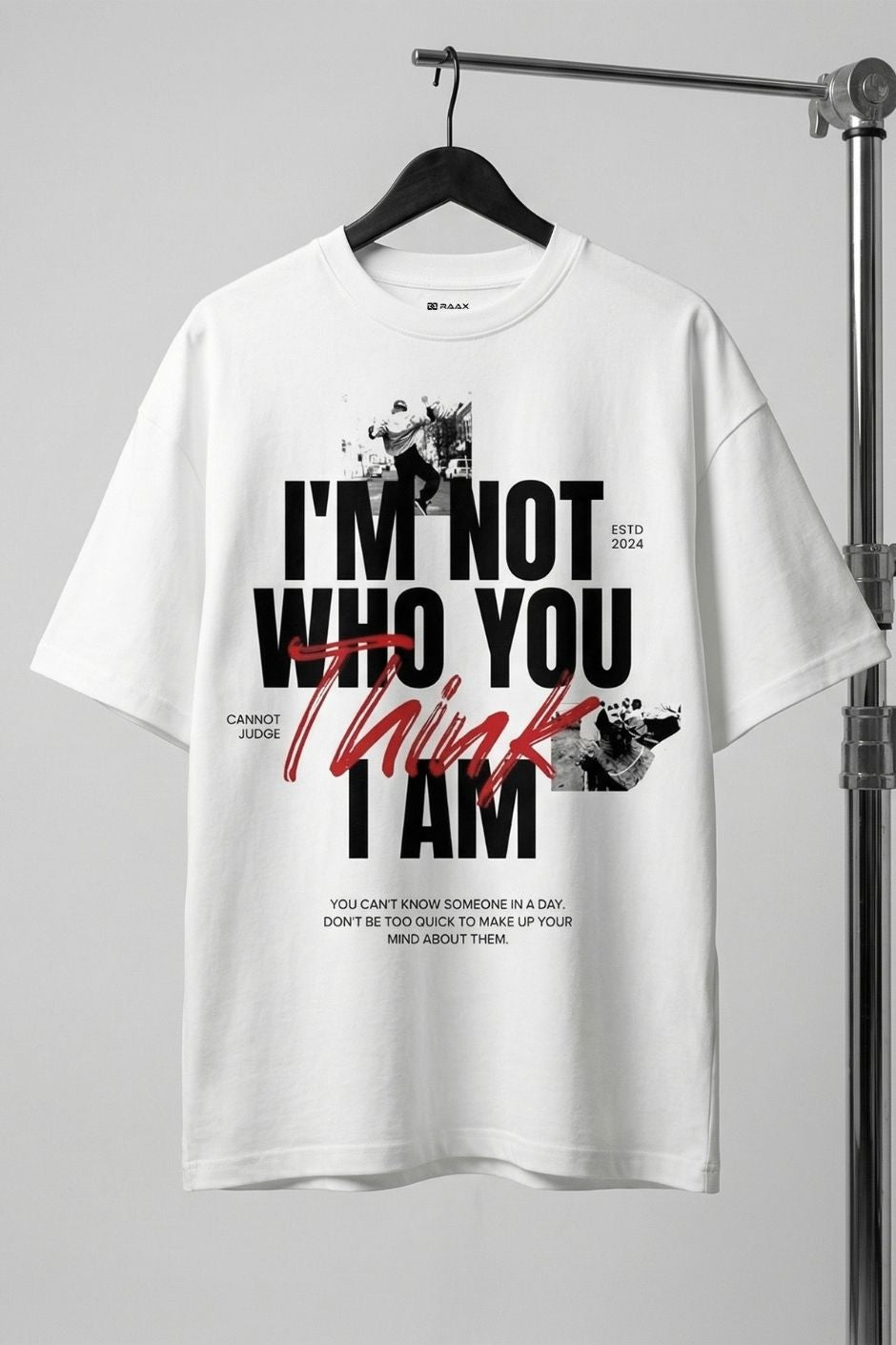 White t-shirt with black and red text on a hanger against a gray background