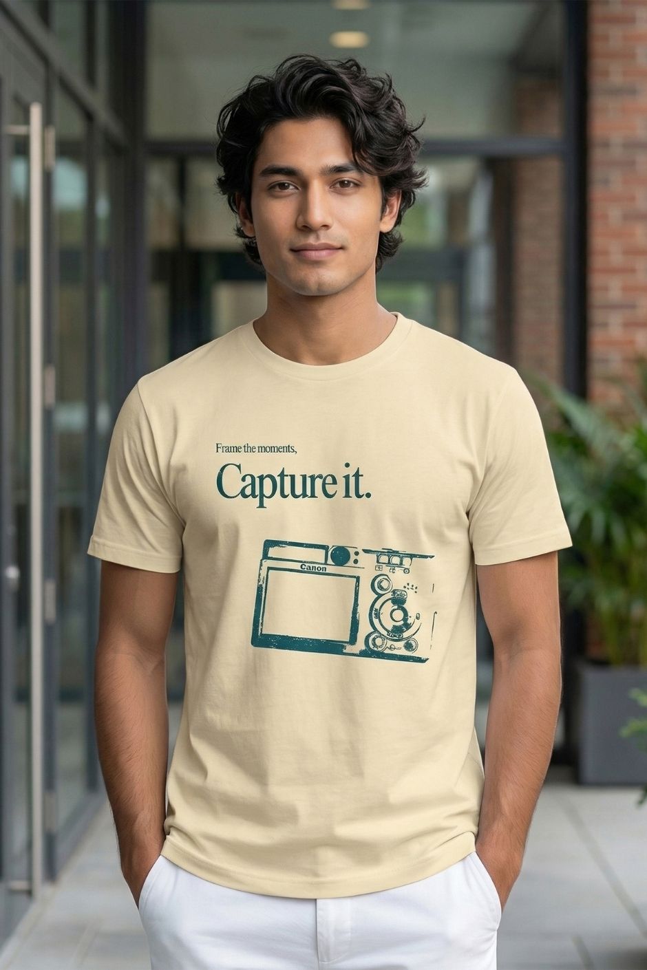 Man wearing a offwhite t-shirt with a graphic design and text outdoors.
