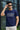 Man wearing a royal blue t-shirt with 'FUTURE' text, holding sunglasses, standing outdoors.
