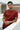 Man wearing a rust t-shirt with a spider design in an indoor setting