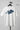 White t-shirt with 'IMPERFECT' graphic on a hanger against a gray background