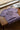 Lilac t-shirt with graphic design on a wooden surface