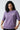 Woman wearing a lilact-shirt with 'The Perfect Retro' text on a plain background