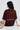 Person wearing a maroon red t-shirt with graphic design and text on a white background