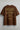 Brown t-shirt with gold text and graphics on a light gray background